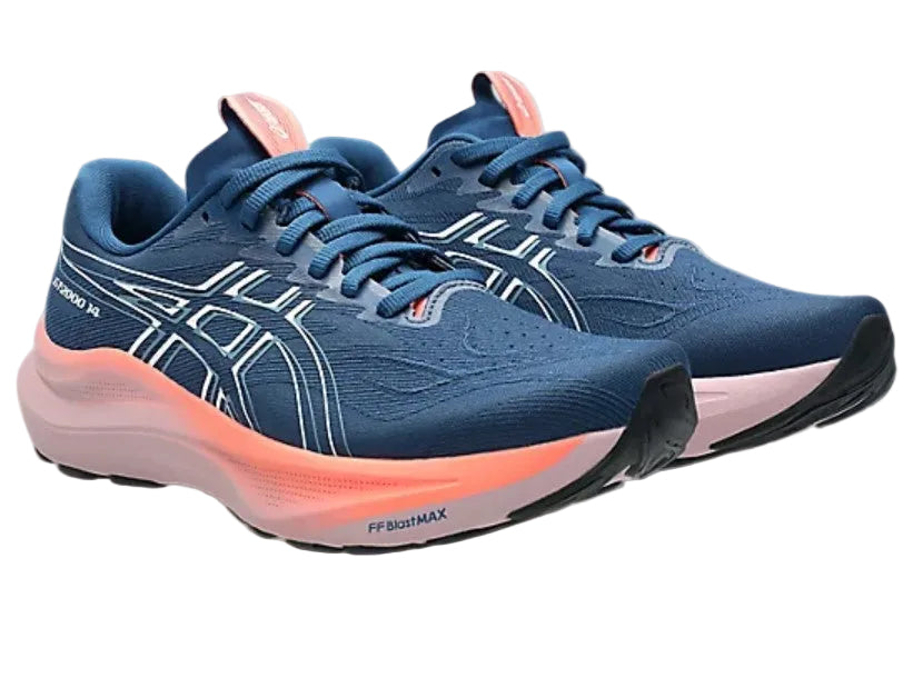 Blue running shoes with pink soles on a gray background