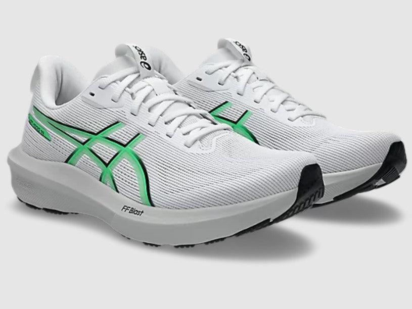White running shoes with green accents on a light gray background