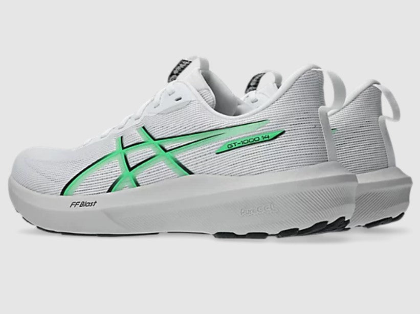 White running shoe with green accents on a light gray background