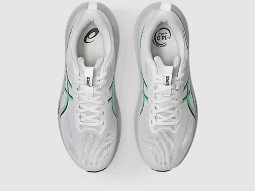 White running shoes with green accents on a white background