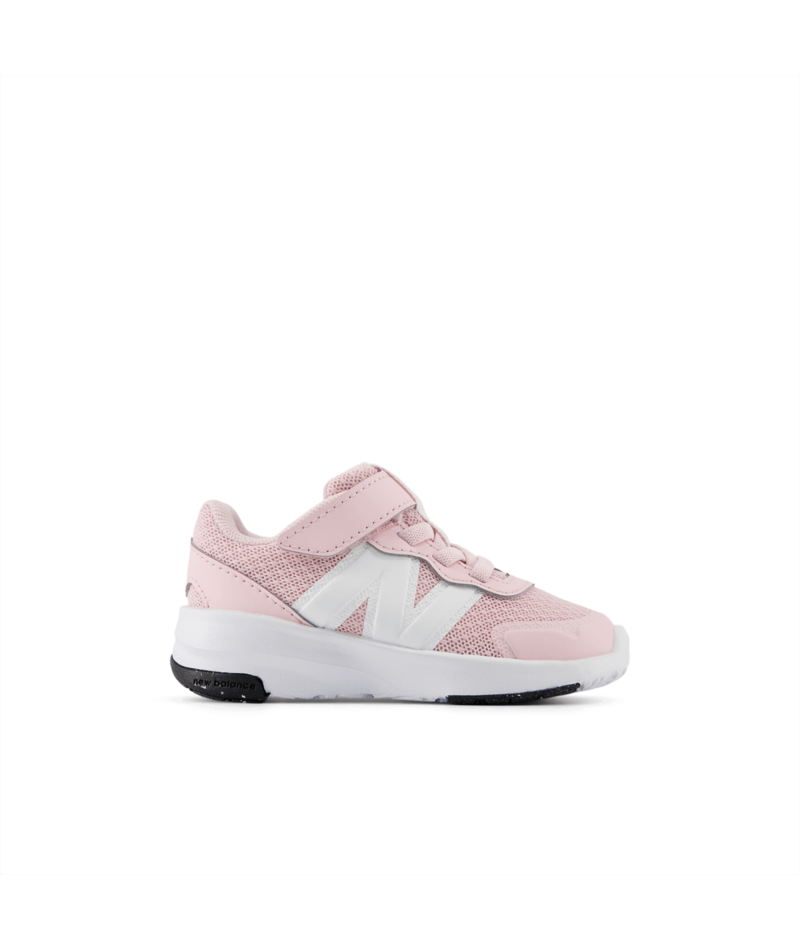 Pink sneaker with white New Balance logo on a white background. Can be purchased at www.sneakersplus.ca