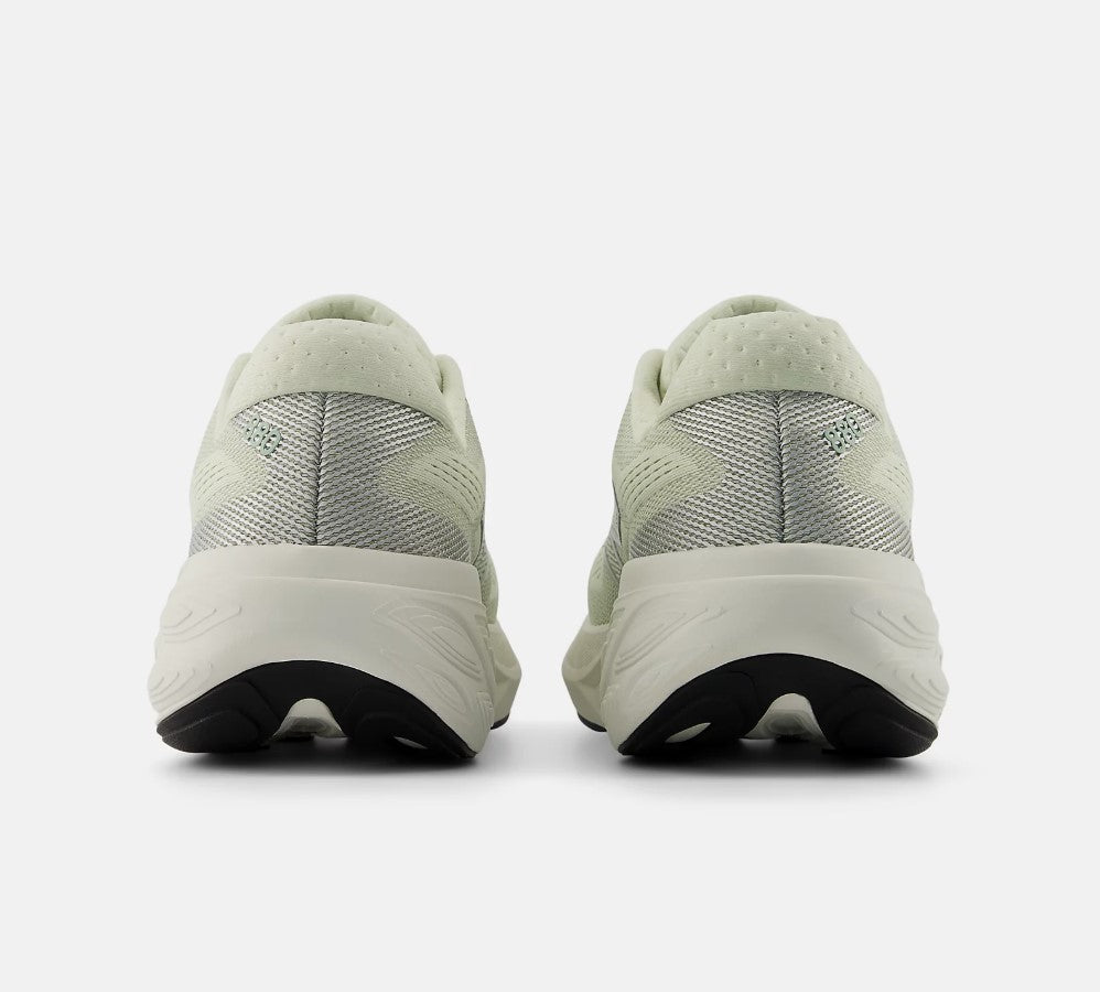 Light green running shoes with white soles on a white background