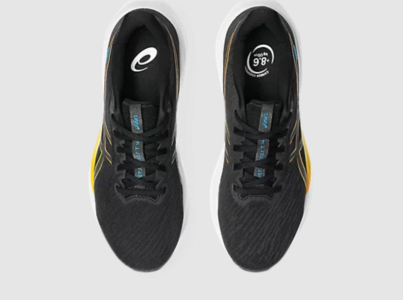 Black running shoes with yellow accents on a white background
