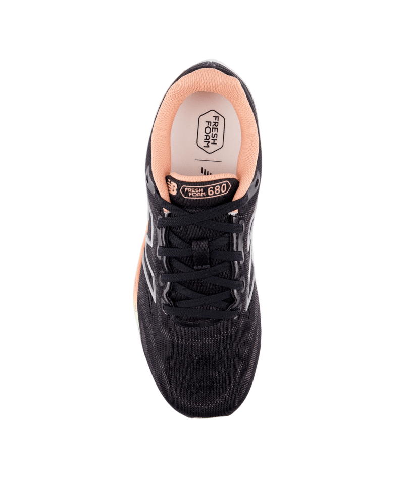 Black sneaker with pink lining on a white background