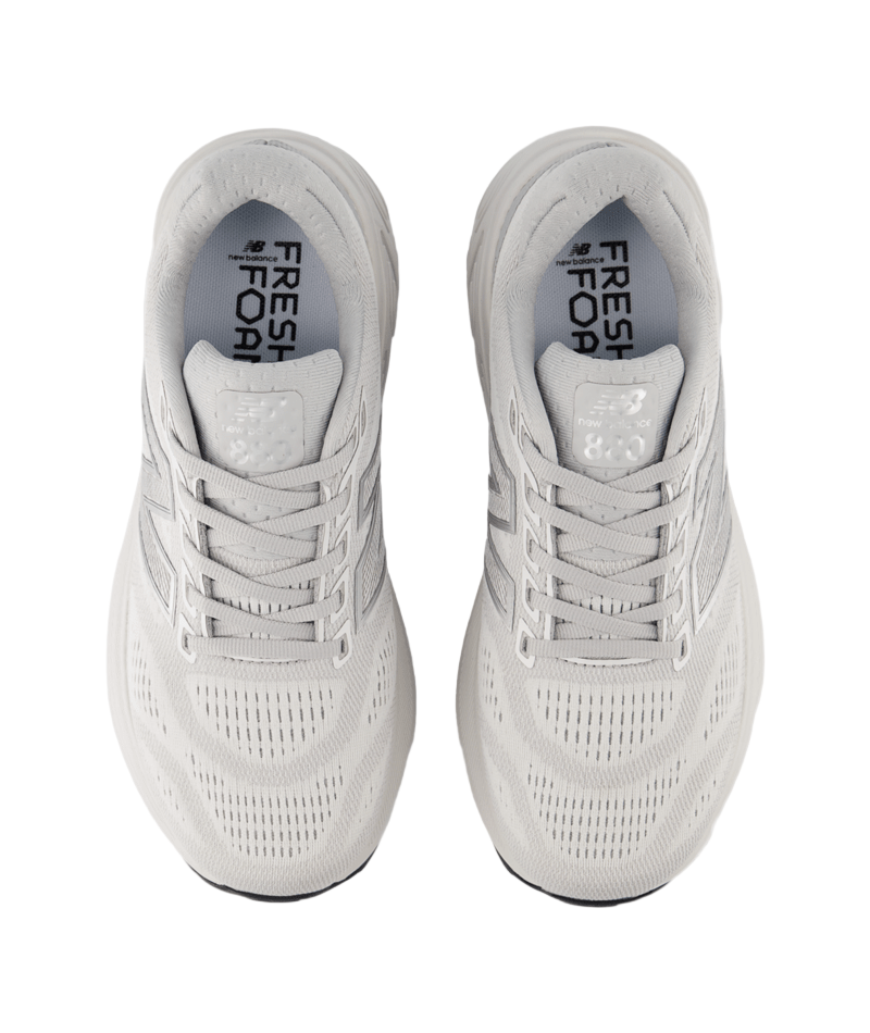 Pair of light gray running shoes with 'Fresh Foam' branding on a white background