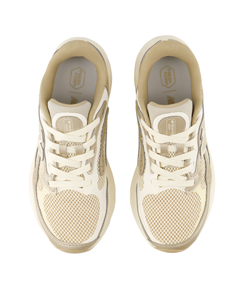 Pair of beige sneakers from the top view on a white background