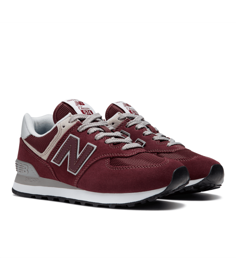Maroon New Balance 574 sneakers with white accents on a white background