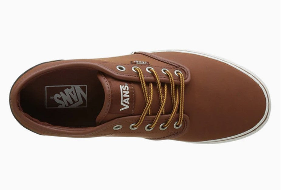 Brown Vans sneaker with yellow laces on a white background