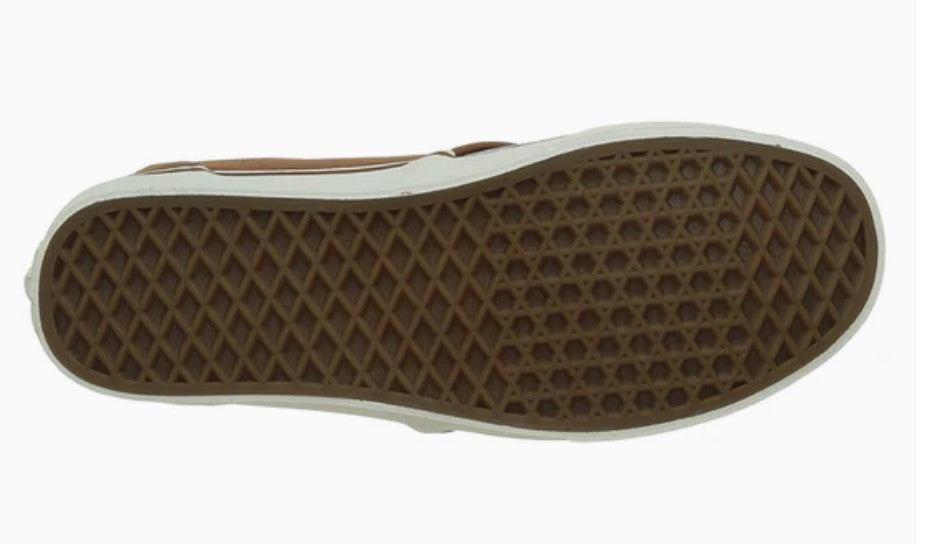 Close-up of a shoe sole with a brown and white pattern on a white background