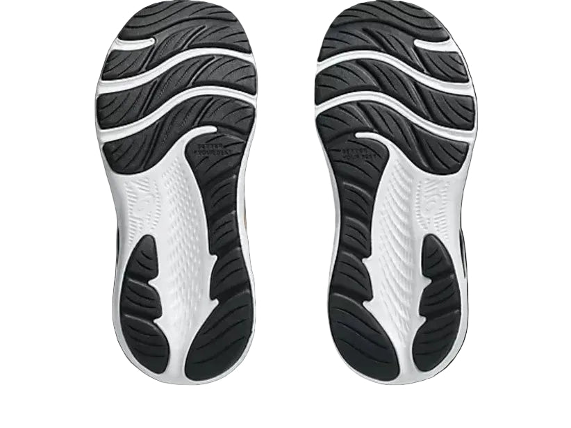Close-up of black and white shoe soles on a light gray background