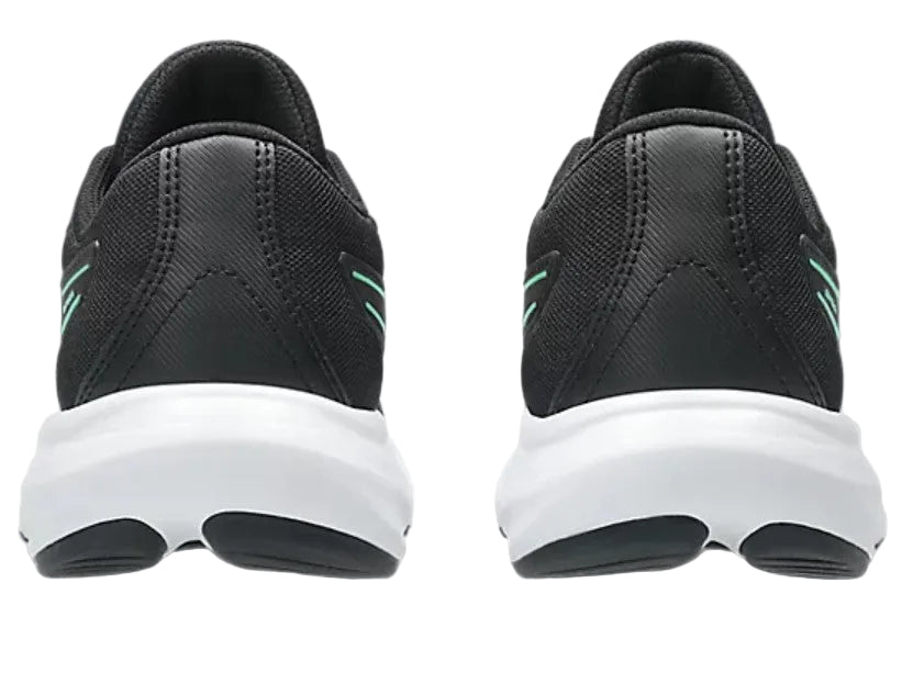 Black running shoes with white soles on a light gray background