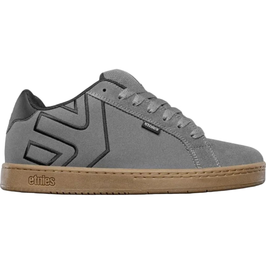 Gray sneaker with brown sole on a light gray background