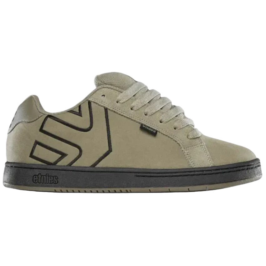 tan sneaker with black Etnies logo on a light gray background