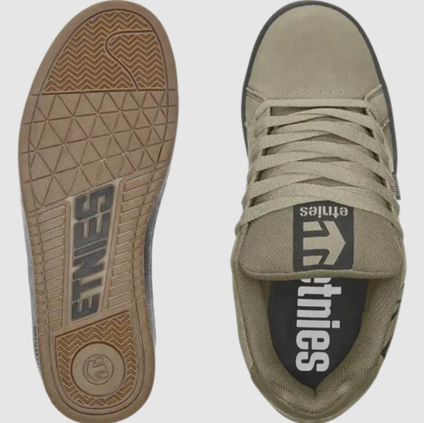Pair of tan sneakers with 'etnies' branding on the sole and tongue on a white background