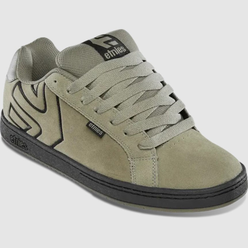 tan sneaker with black accents on a white background