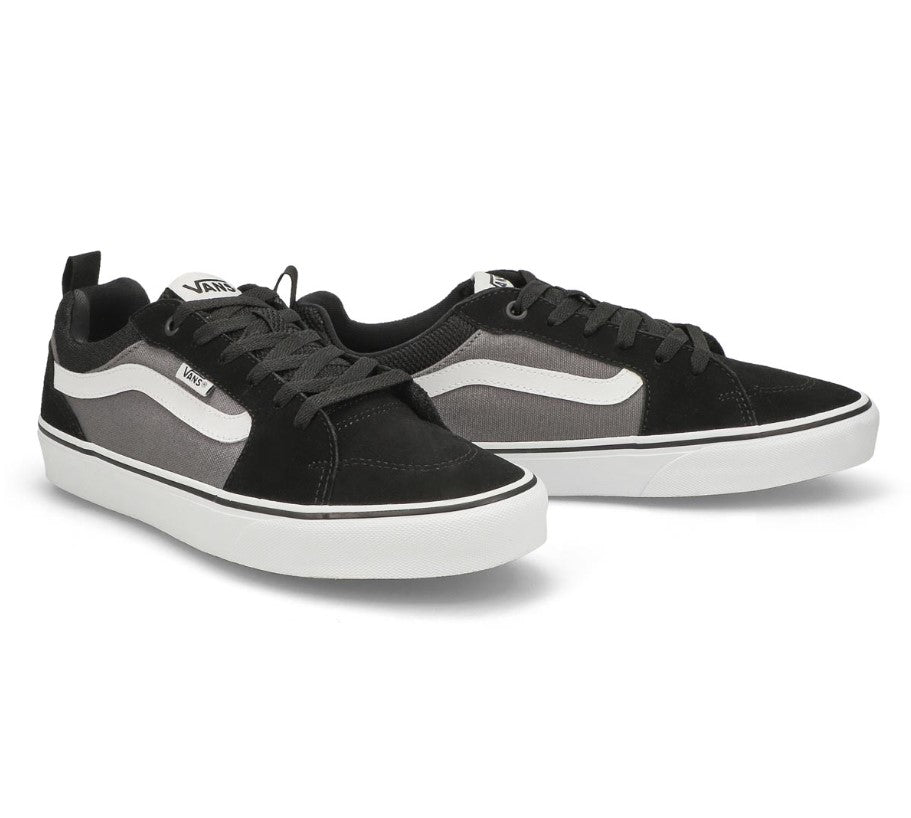 Black, grey, and white vans sneaker on a white background
