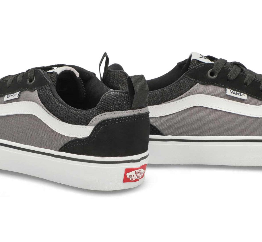 Black and gray Vans sneakers with a white sole on a white background