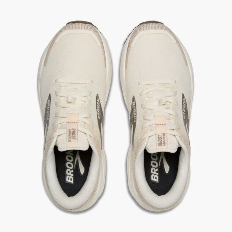 Pair of white running shoes with visible branding on a white background