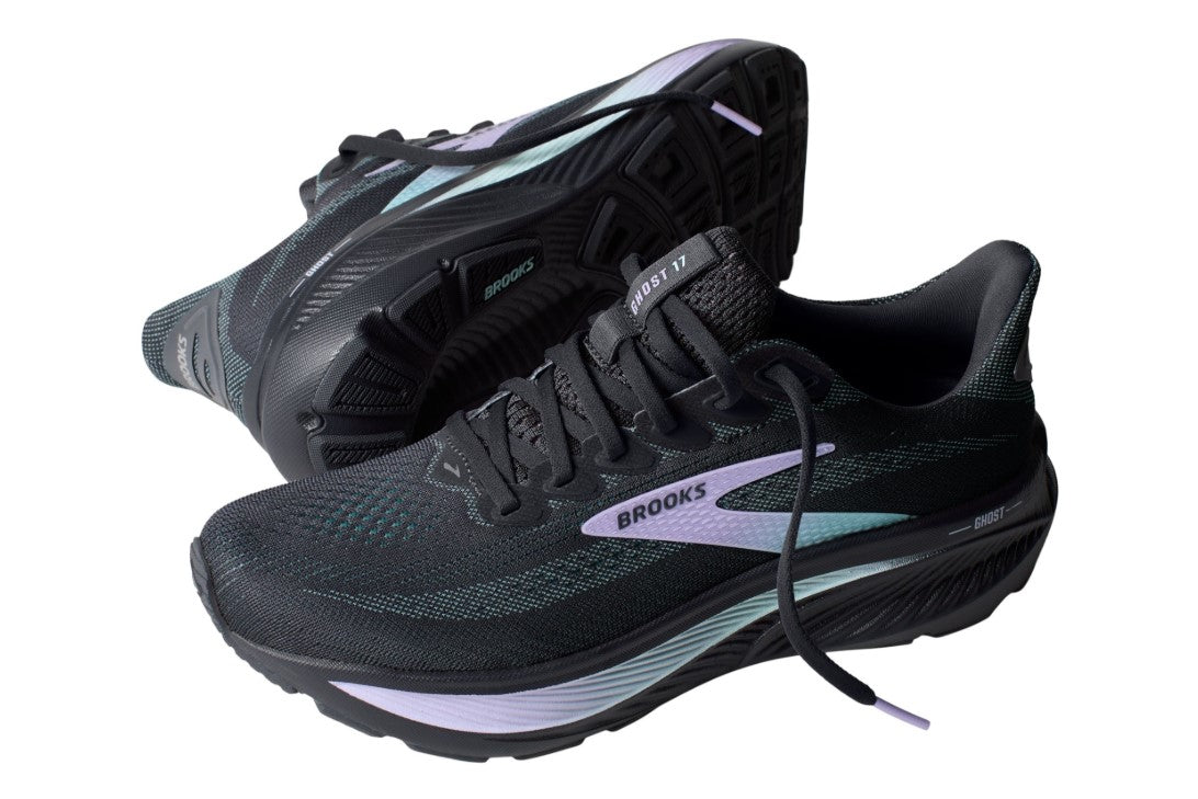 Black running shoes with purple and blue Brooks logo on a white background