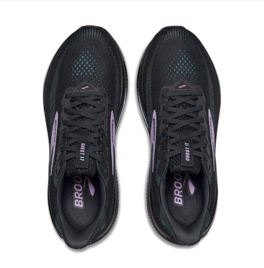 Black running shoes with purple accents from a top down view on a white background