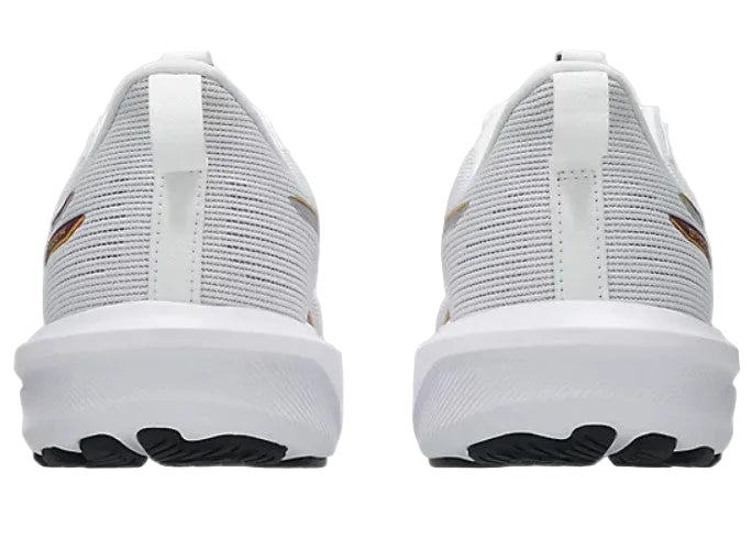 White athletic shoes with black soles on a light gray background