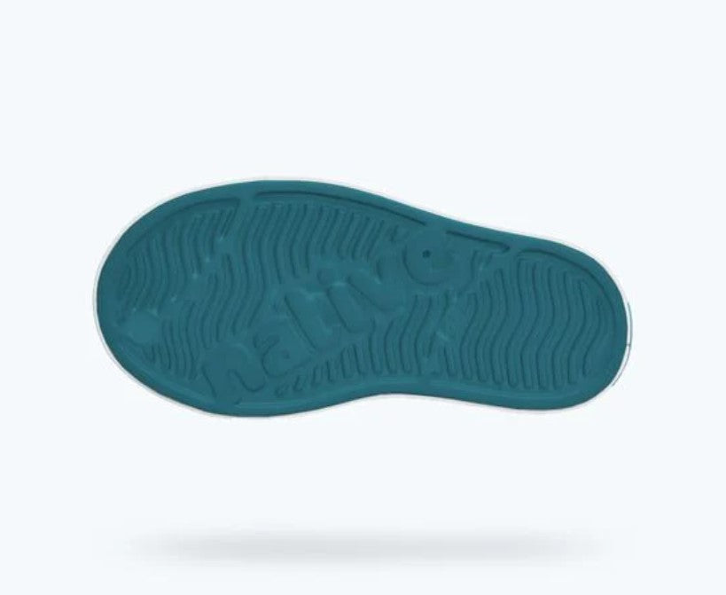Teal sole of a shoe on a white background
