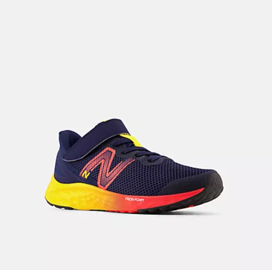 Navy running shoe with colorful sole on a light gray background