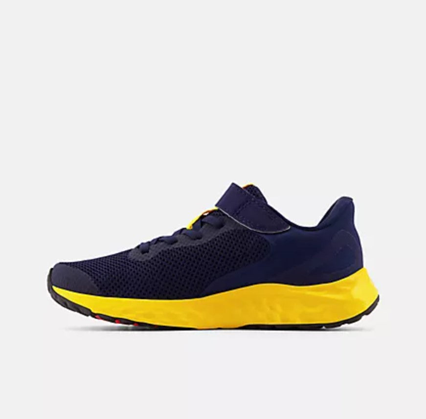 Navy and yellow running shoe on a light gray background