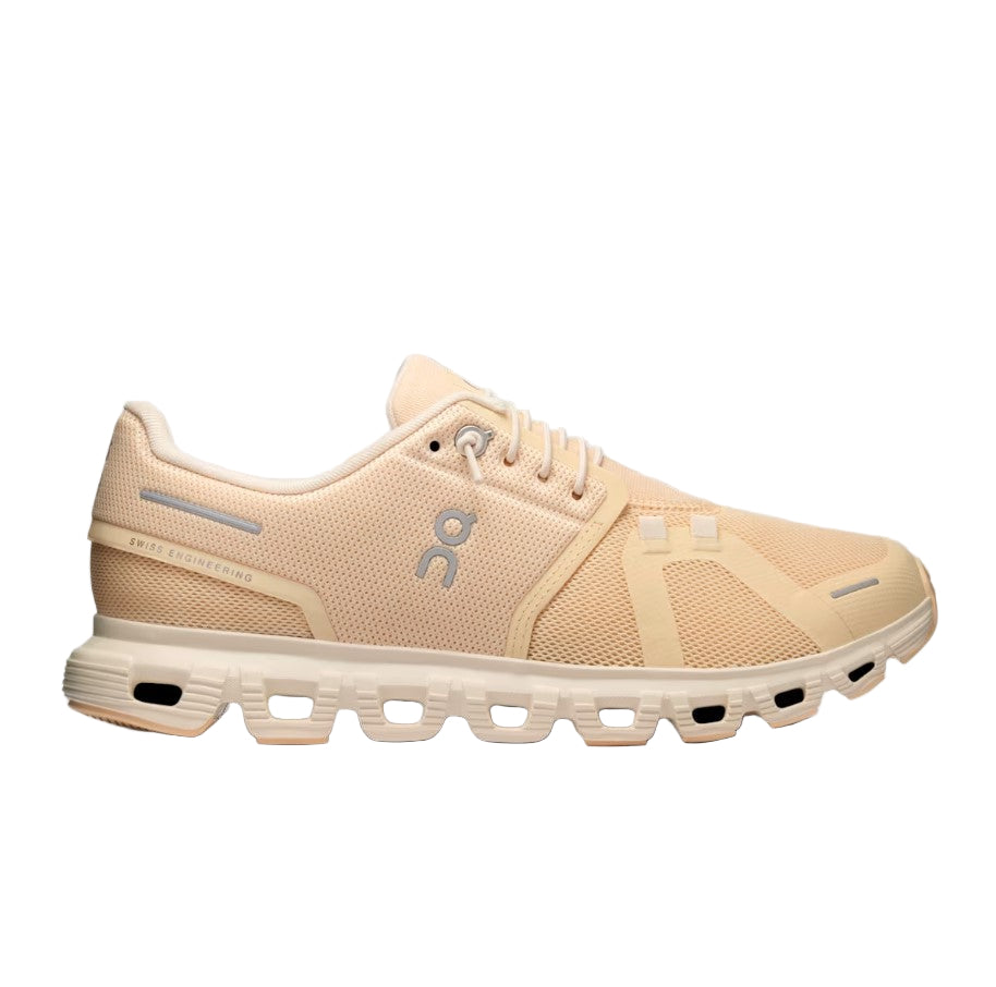 Beige/peach running shoe on a white background