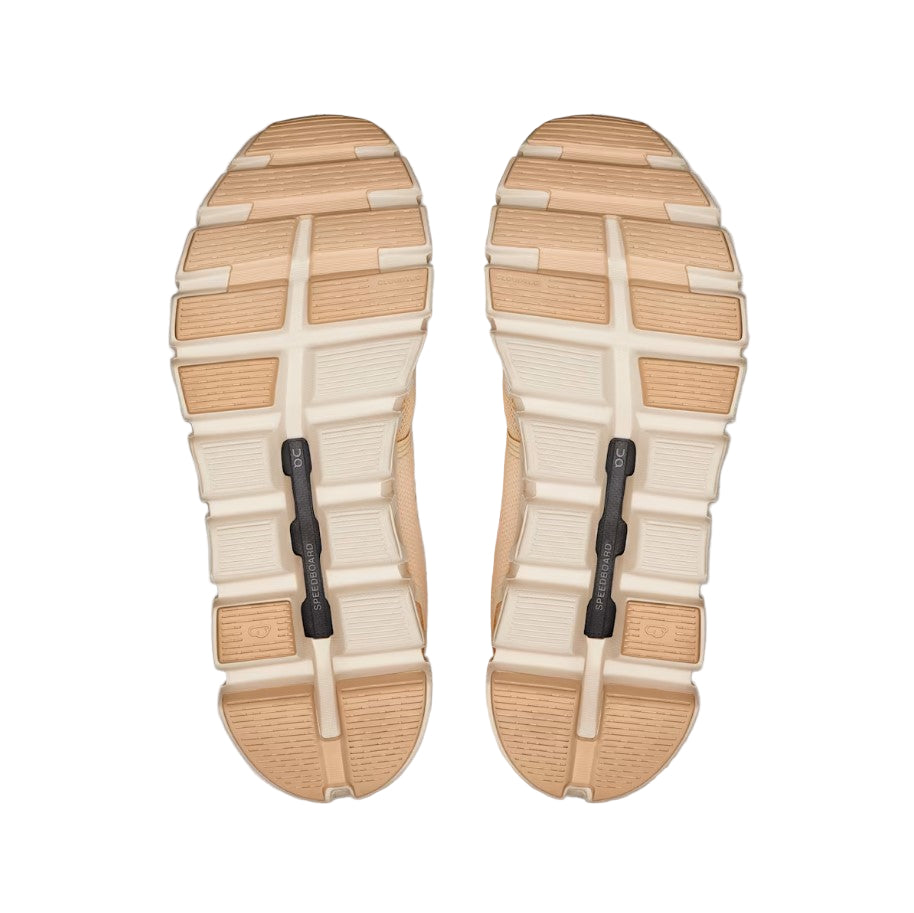 beige and peach shoe soles on a white backgoround