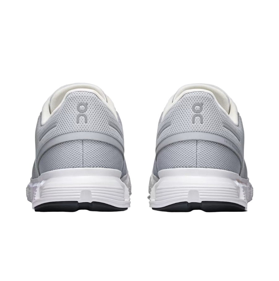 Gray and white running shoes with a visible brand logo on a light gray background