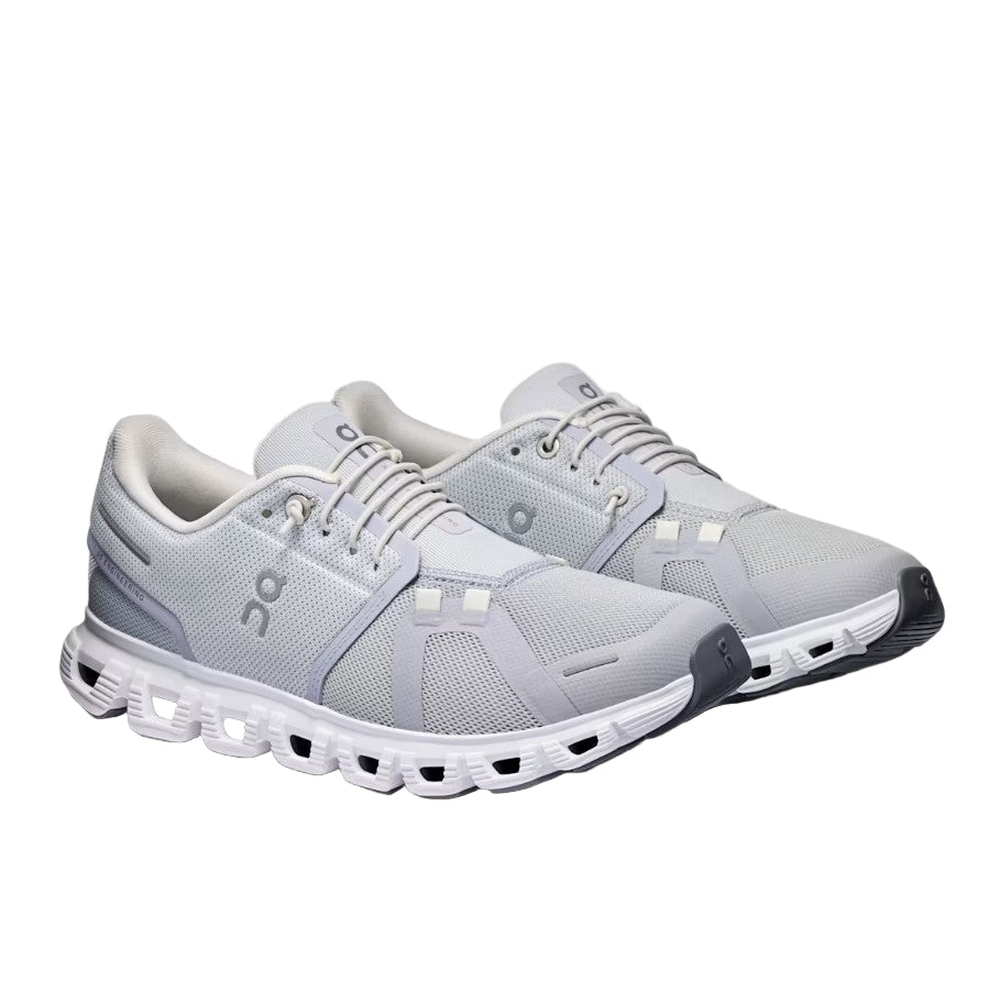 Gray running shoes with white sole on a light gray background