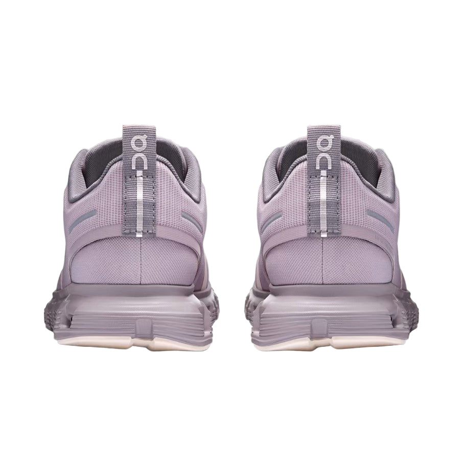 Pair of purple running shoes with visible 'On' branding on a light gray background