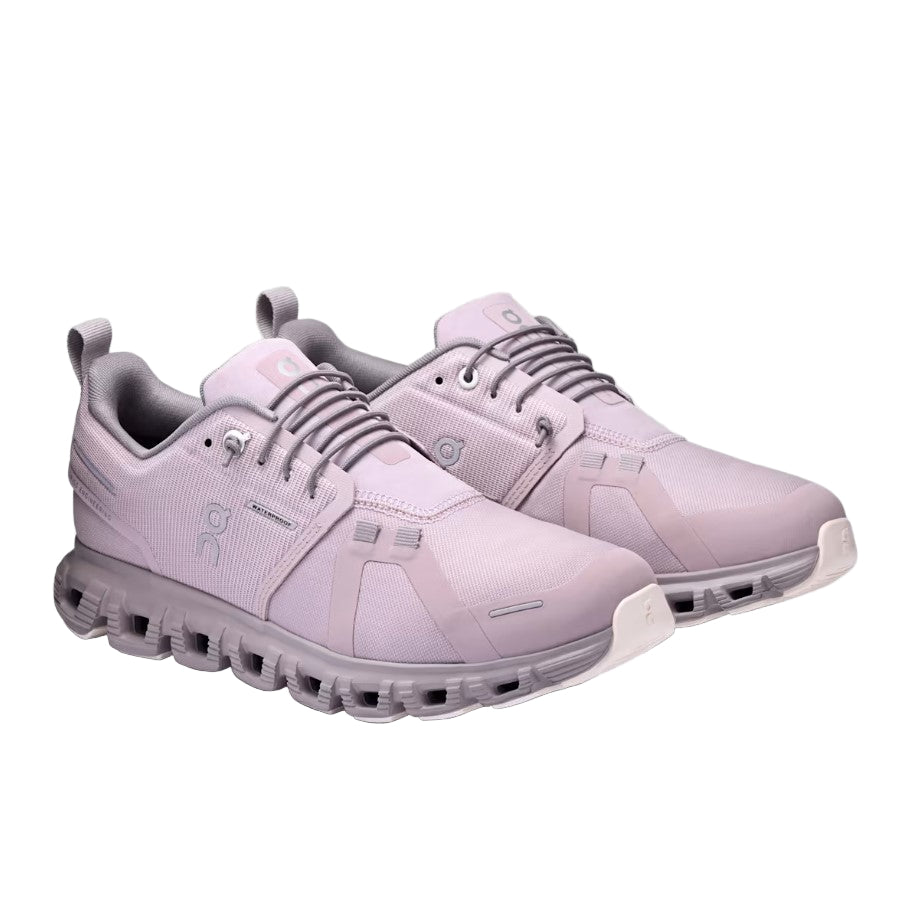 Pair of light purple athletic shoes on a gray background