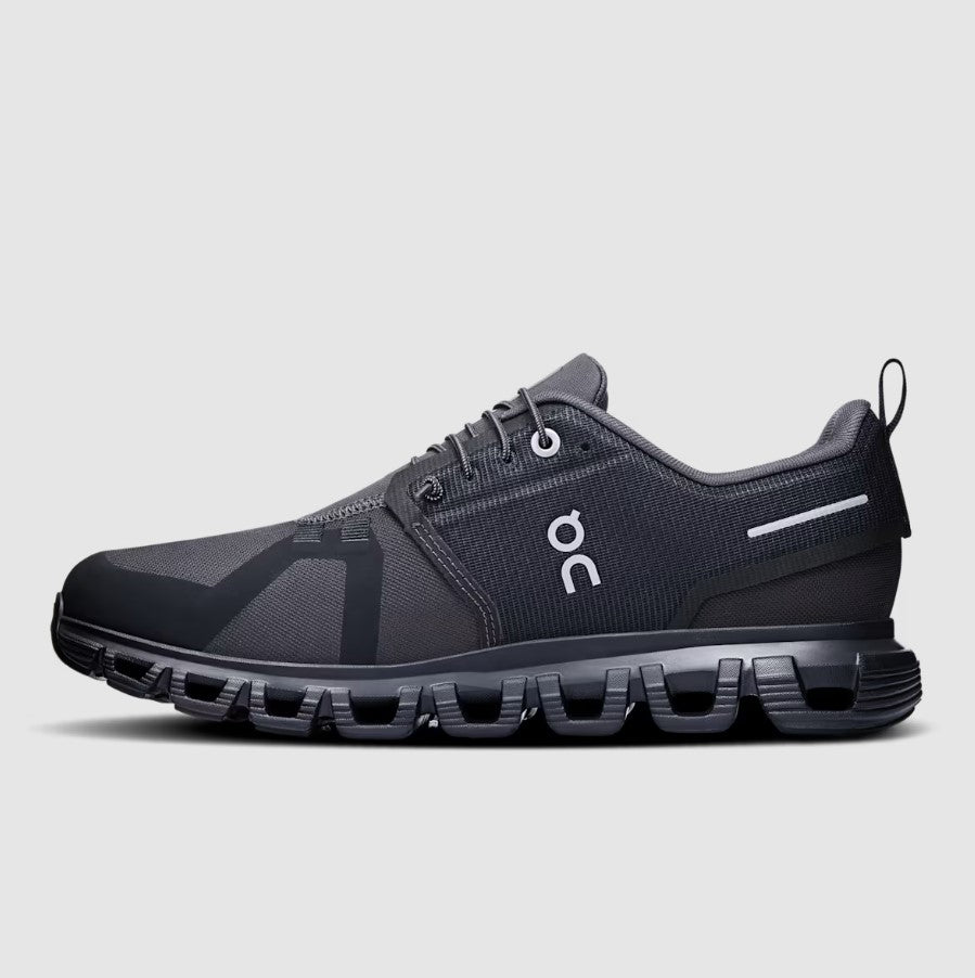Black running shoe with visible brand logo on a gray background