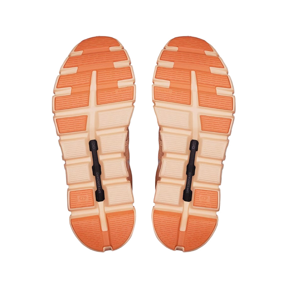 Pair of orange and beige shoe soles on a white background
