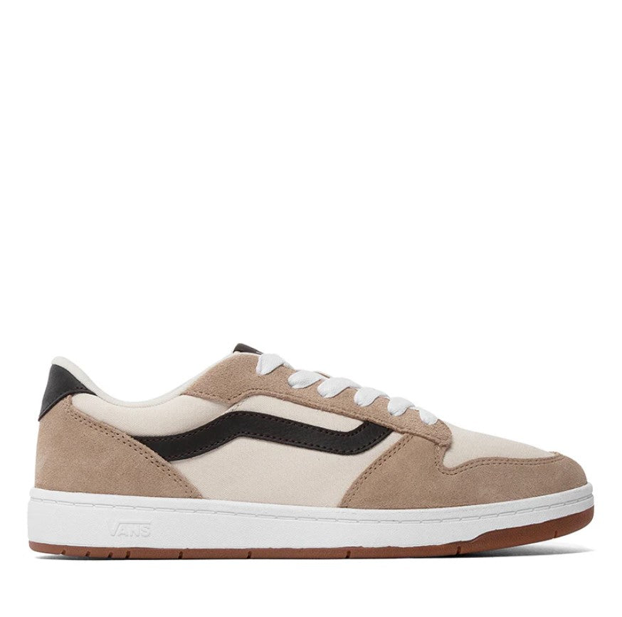 Beige and black sneaker with white sole on a white background