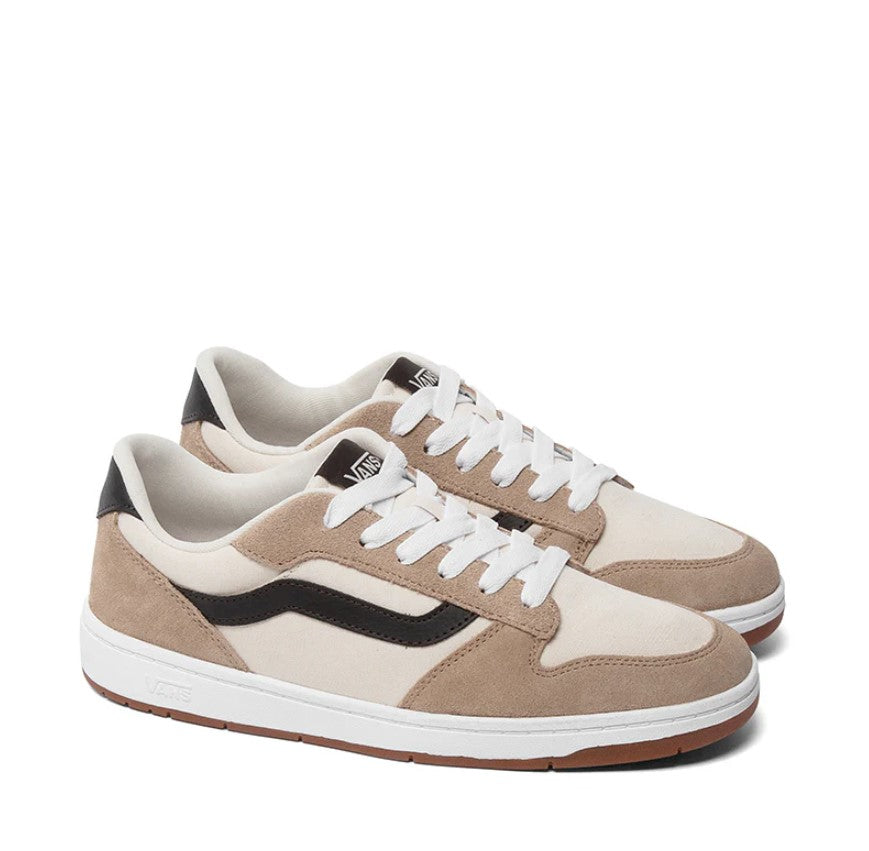 Pair of beige and brown sneakers with white laces on a white background