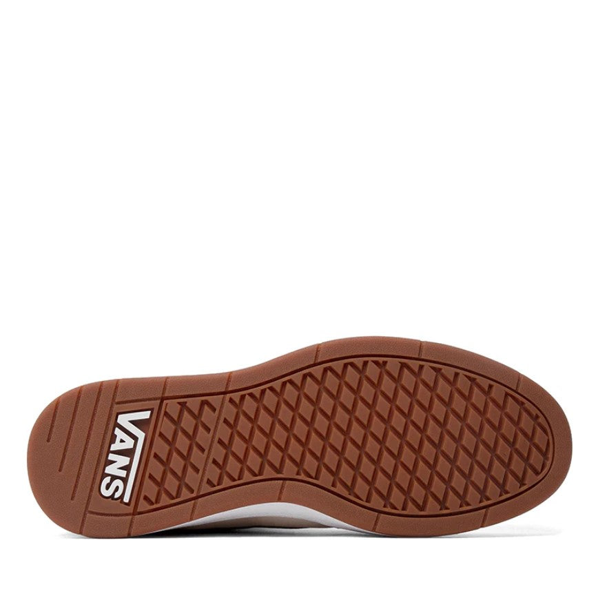 Brown sole of a shoe with Vans logo on a white background