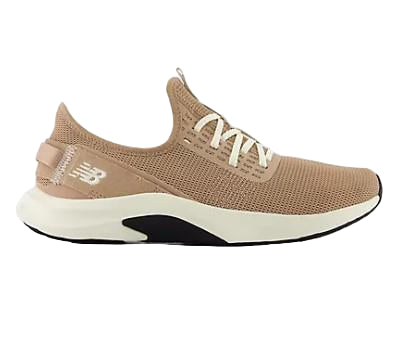 A pair of beige New Balance women's training shoes with a textured upper and a lace-up closure.