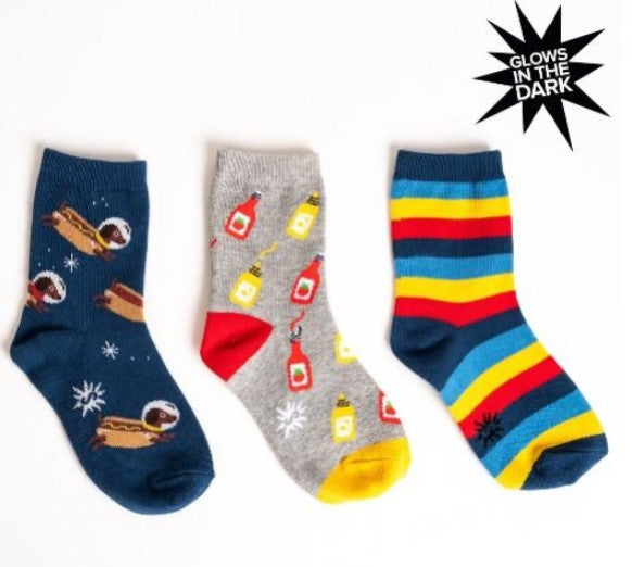 Three pairs of socks with different hot dog related, like Weiner dogs and mustard with ketchup designs on a white background