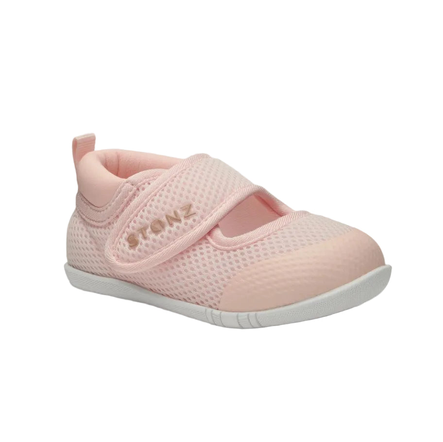 Pink baby shoe with a white sole on a light gray background