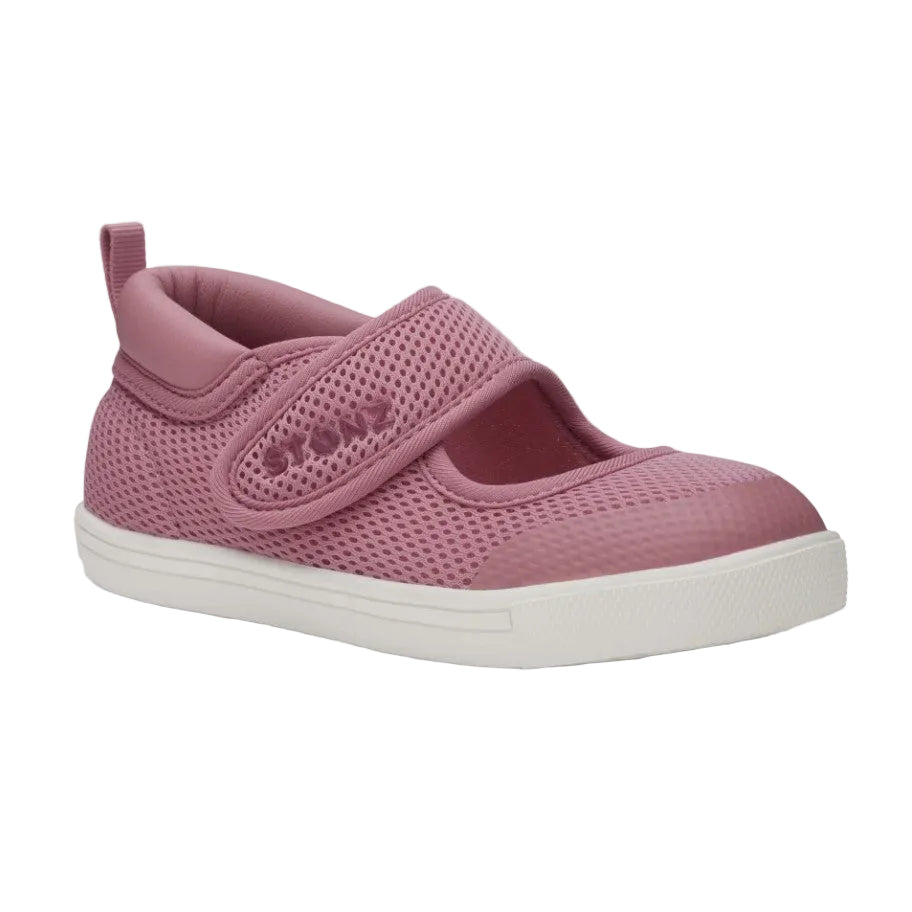 Pink children's shoe with a white sole on a light gray background