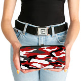 Person holding a red and black camouflage wallet with a plain background