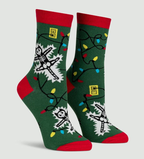 Green socks with skeleton and Christmas lights design on a light gray background