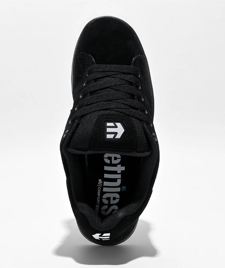 Black sneaker with a white brand logo on a white background