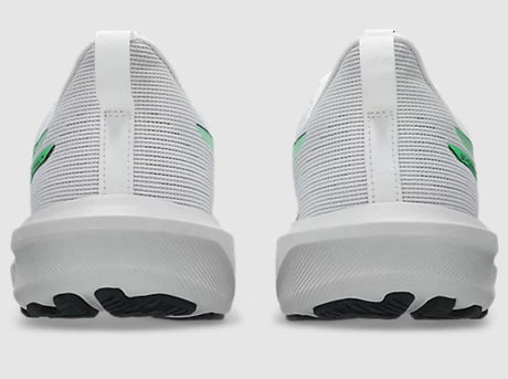 White sneakers with green accents on a light gray background