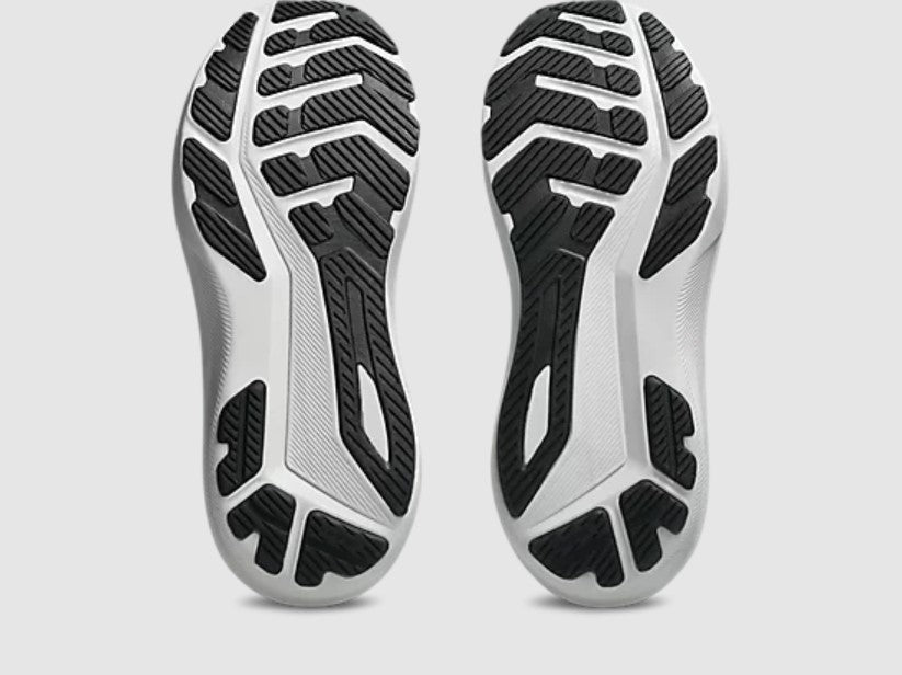 Close-up of a pair of black and white athletic shoes on a light gray background