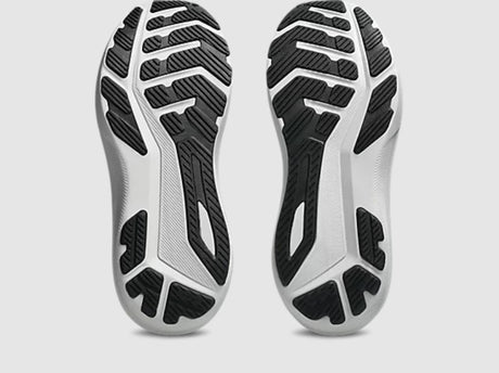 Close-up of a pair of black and white athletic shoes on a light gray background