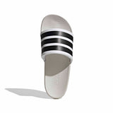 White slide sandal with black stripes on a white background
